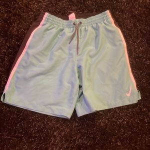 Nike men’s turquoise and black swimming trunk. Built in netting